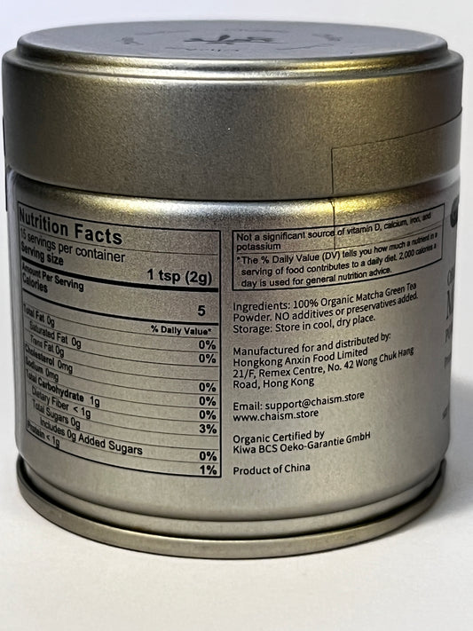 A close-up of a cylindrical metal tin showing the back label with nutrition facts and product details for Charim matcha green tea powder.